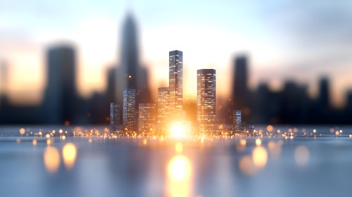 Image of a city with brightly lit skyscrapers against a blurred city skyline. The lights sparkle and reflect on the water\'s surface, with the sunset in the background providing a warm glow to the sky.