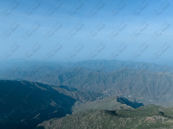 A shot of a series of mountains and green areas in the city of Abha in southern Saudi Arabia, houses on mountain heights, nature in Saudi Arabia