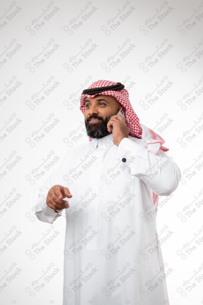 Portrait of a Saudi man holding a phone and making a phone call with different expressions