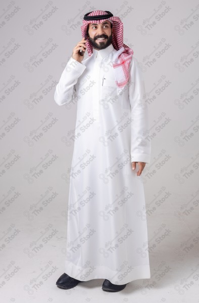 Portrait of a Saudi man holding a phone and making a phone call with different expressions