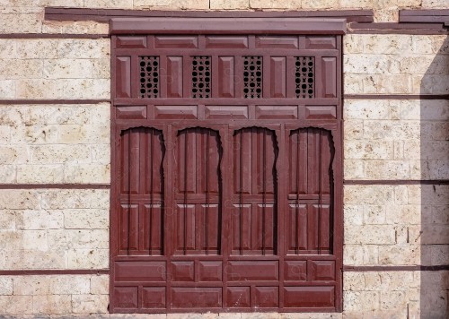 Wooden Antique door built into mud wall - Old traditional wooden door in Saudi Arabia