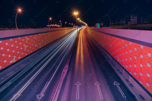 A time-lapse shot of King Abdullah Road in Riyadh, reflecting the speed of cars in the brilliance of their lights on the streets of Riyadh at night