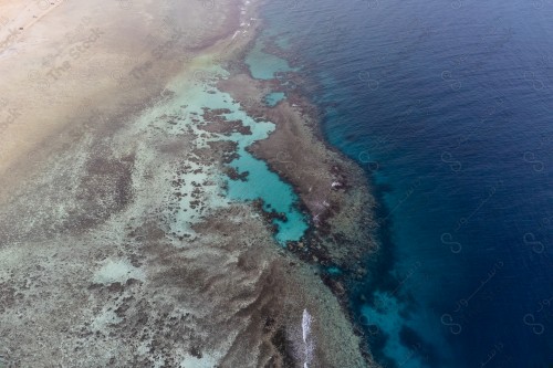 An aerial shot of the coral reefs in Shuaiba, on one of the beaches in Jeddah. Clear sea water.