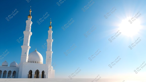An image of a mosque with Islamic architectural style featuring white domes and tall minarets topped with golden domes. The sky is clear blue with the sun shining brightly on the right side of the image.