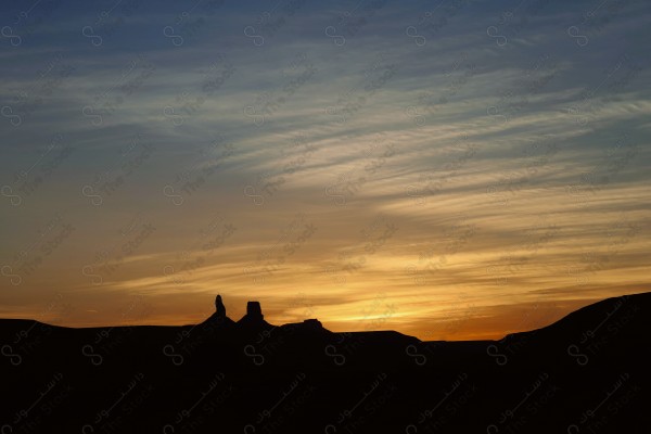 Silhouette shot of the sunset in Al-Hariq Governorate, south of Riyadh, a series of rocky mountains, nature in Saudi Arabia