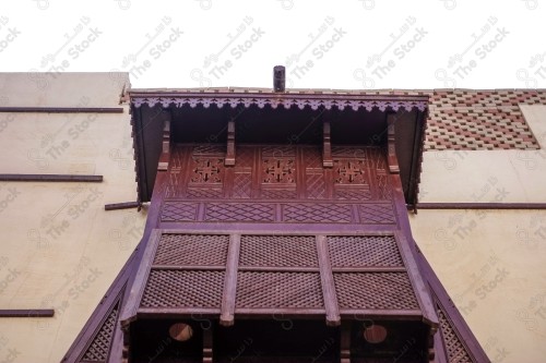 Detail of an old wooden window in a mud wall, decorative wooden window.