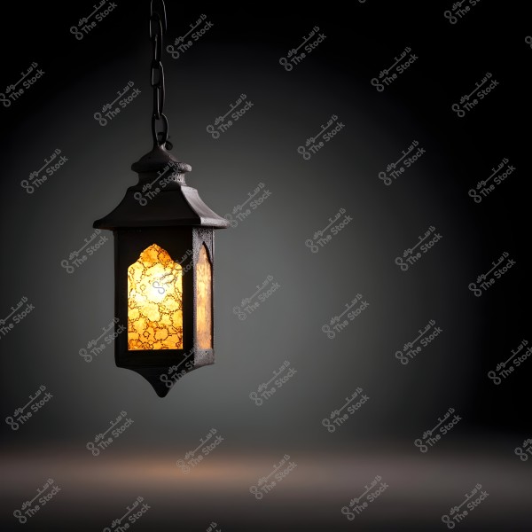 Image of a traditional lantern hanging by a chain, glowing with a warm yellow light inside glass intricately decorated with patterns. The background is dark and shadowy, highlighting the lantern\'s beauty and antique design.