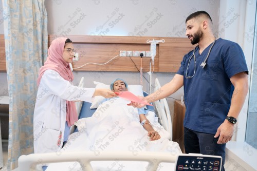 Saudi female doctor and paramedic in medical uniform and examining and applying nutritional solution, medicine and health care