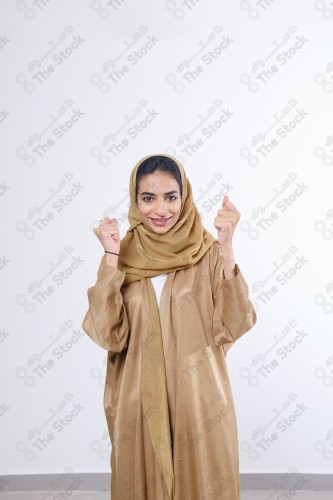 Portrait of a Saudi girl making different expressions, on a white background