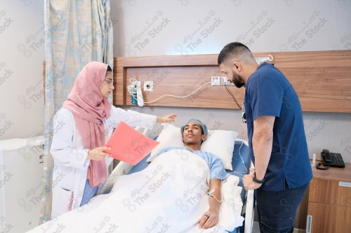 Saudi female doctor and paramedic in medical uniform and examining and applying nutritional solution, medicine and health care