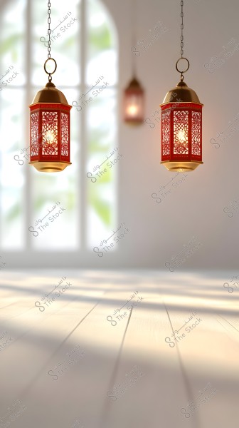 Two hanging lanterns with intricate designs in red and gold are suspended from the ceiling of a room illuminated by sunlight, with an arched window design in the background, beautifully reflecting light on the wooden floor.