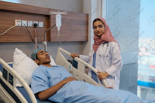 A Saudi female doctor wears a medical uniform and is examining and applying a nutrient solution, medicine and health care