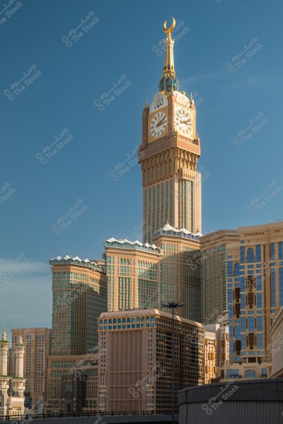 Image of the Makkah Royal Clock Tower in Mecca, Saudi Arabia. The tall tower features a large clock face and Islamic decorative elements, with an architectural structure showcasing ornate designs and an elegant facade, topped with a prominent golden crescent.