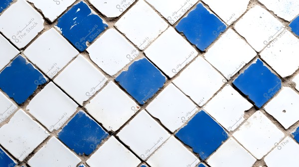 An image of ceramic tiles arranged diagonally, featuring alternating squares of white and blue tiles. The tiles show some wear with slightly chipped corners, and cement mortar is visible between the joints.