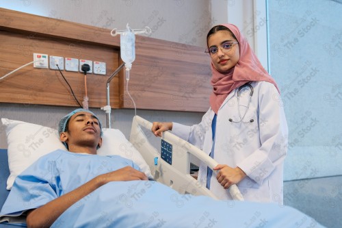 A Saudi female doctor wears a medical uniform and is examining and applying a nutrient solution, medicine and health care