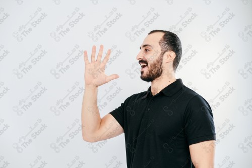 Portrait of a Saudi man on a white background making hand gestures while smiling, souvenir photos, documenting a happy moment