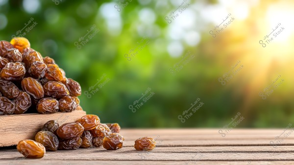 An image of brown dates placed on a wooden surface, with the sun shining in the background, providing a vibrant natural setting. The dates are clustered together, with some scattered on the table.