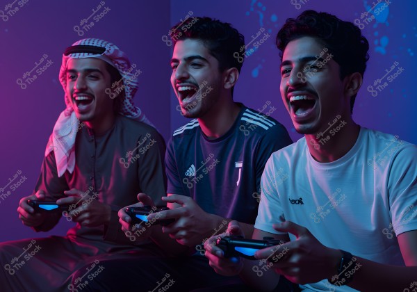 The image shows three young men sitting in a room illuminated with purple and blue lights, attentively looking at something out of frame and excitedly interacting as they play with video game controllers. The first young man is wearing a traditional Gulf-style outfit including a thobe, ghutra, and agal, while the other two are dressed in casual sportswear, including short-sleeve shirts.
