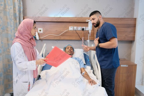 Saudi female doctor and paramedic in medical uniform and examining and applying nutritional solution, medicine and health care