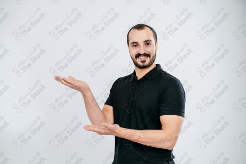 Portrait of a Saudi man on a white background making hand gestures while smiling, souvenir photos, documenting a happy moment