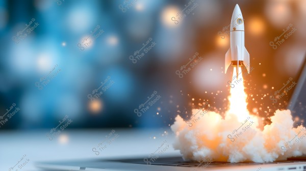 Image of a small rocket launching above a laptop keyboard. The rocket is on the right side of the image, producing flames and a burst of white smoke underneath its engines. The background is blurry with blue and orange colors, conveying a sense of creativity and innovation.