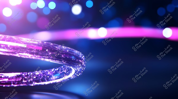 Image of a glowing purple ring-shaped object in the center, appearing to float in the air with a blurred background featuring multiple light spots in blue and pink. The light effect gives the image a digital or futuristic impression.