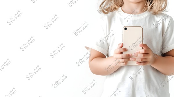 Image of a child holding a smartphone in their hands, wearing a white shirt. The photo shows the upper part of the child\'s body against a white background, with a focus on the smartphone.