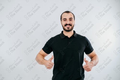 Portrait of a Saudi man on a white background making hand gestures while smiling, souvenir photos, documenting a happy moment