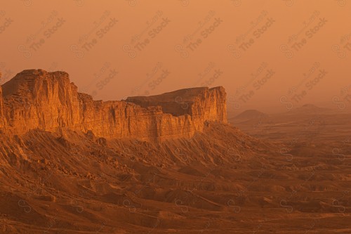 A shot of a rocky mountain chain at sunset, of the Tuwaiq mountain range in the Najd region