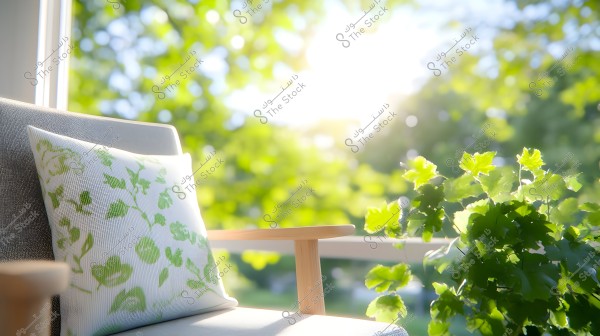 The image shows a wooden chair with an armrest, adorned with a white cushion featuring green floral patterns. To the right, there are bright green leafy plants glowing in sunlight. In the background, green trees are visible with sunlight filtering through the leaves.