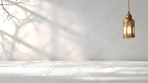 An image of a hanging golden lantern with a geometric Eastern design against a white wall background, featuring shadows of tree branches on the light wall and soft lighting reflecting on the white floor.