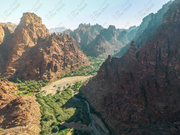 An aerial shot of Wadi Al-Disa in Tabuk, showing the mountains during the day, Saudi valleys, and nature in Saudi Arabia.