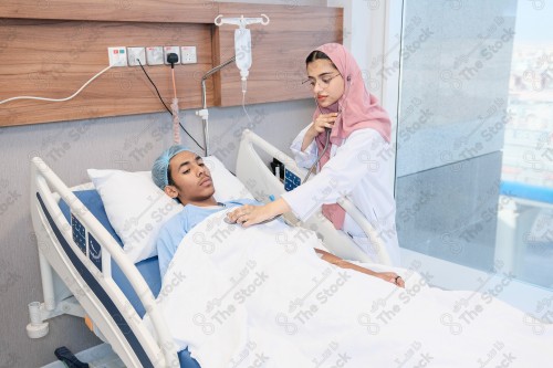 A Saudi female doctor wears a medical uniform and is examining and applying a nutrient solution, medicine and health care