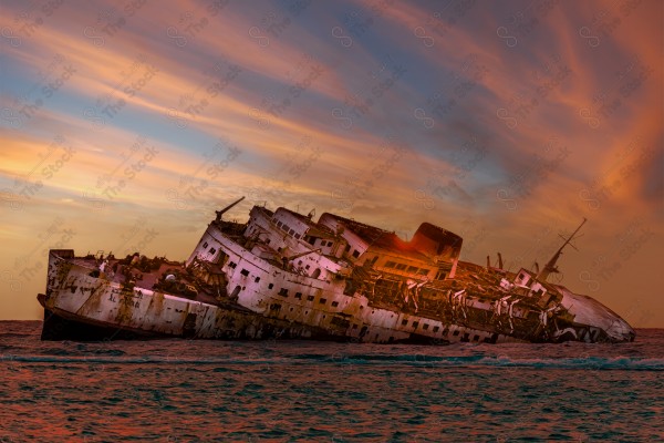 A snapshot of the wreck of a Greek ship sunk in the Jeddah Sea, showing a cloudy sky during sunset, traces of a sunken ship in the sea, Jeddah, old ships.