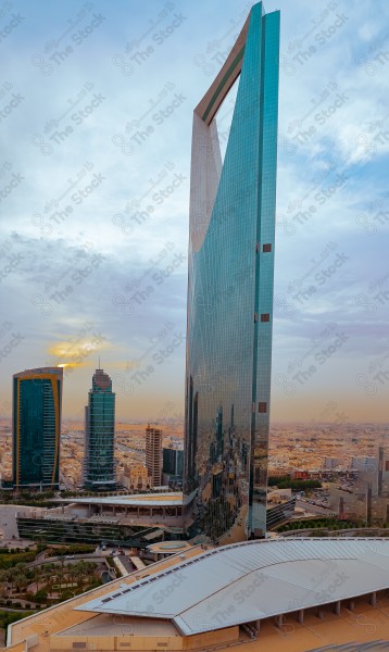 An aerial shot of the Kingdom Tower in the capital, Riyadh, showing a cloudy sky during the day and traffic in the city of Riyadh