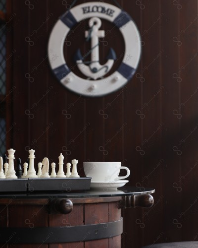 Hot coffee, coffee mug on the table, chess game.