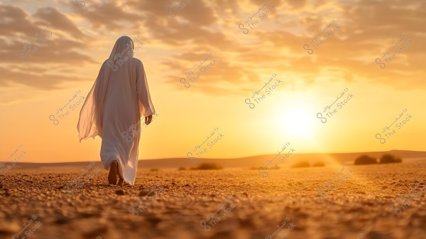 An image of a person walking in the desert during sunset. The person is wearing a traditional white robe, suggesting Middle Eastern origin. The horizon is filled with the warm colors of the sunset, and the sky has scattered light clouds. The ground is sandy with a few distant shrubs.