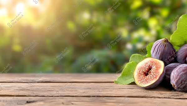 An image showing a group of round purple figs placed on a wooden surface. One of the figs is cut in half, revealing its internal seeds clearly. The background features a blurry mix of green foliage and sunrays, adding a warm glow to the scene.
