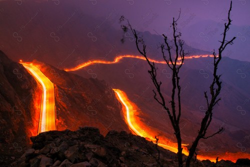 A time-lapse shot of paved roads in the middle of the rocky mountains in the city of Taif, western Saudi Arabia, a series of rocky mountains.