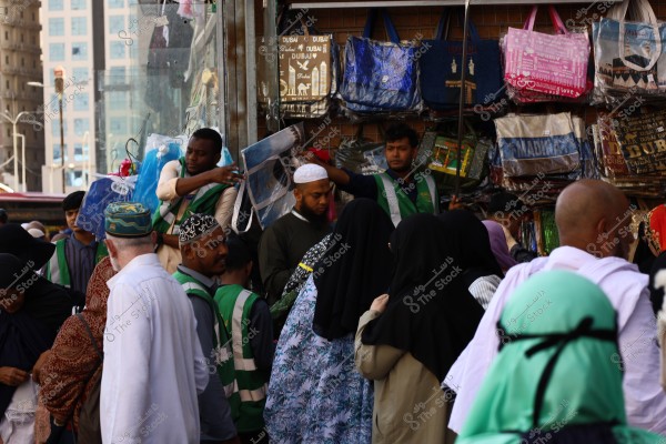 Mecca, Saudi Arabia - March 12 2025: people buying products from market shop in Mecca close to Masjid al-Haram, pilgrims umrah shopping in Makkah