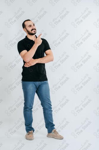 Portrait of a Saudi man on a white background making hand gestures while smiling, souvenir photos, documenting a happy moment