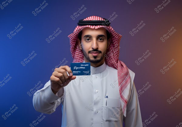 An image of a man wearing traditional Saudi attire, including a white thobe and a red and white ghutra, holding a blue card in his hand. The thobe is white with a pocket containing a pen. The background features a gradient of blue to orange, creating a calm atmosphere.