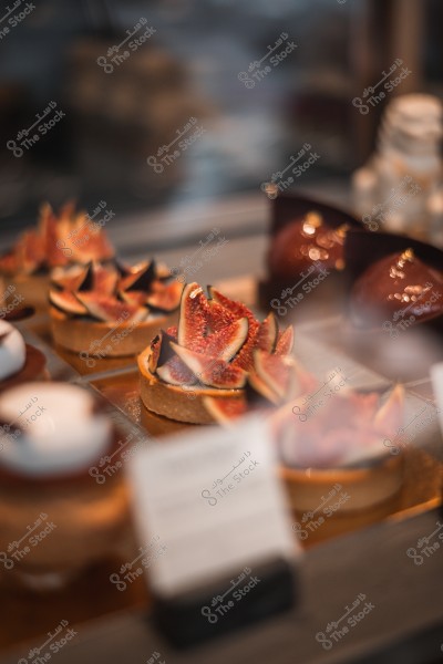 Fresh fig tarts displayed in a dessert shop.