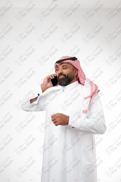 Portrait of a Saudi man holding a phone and making a phone call with different expressions