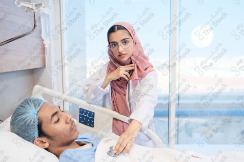 A Saudi female doctor wears a medical uniform and is examining and applying a nutrient solution, medicine and health care