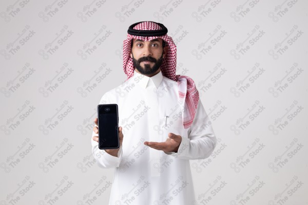 Portrait of a Saudi man holding an automatic payment device and making different expressions