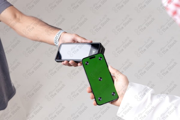 Portrait of a Saudi man holding a card and making automatic payments on a white background