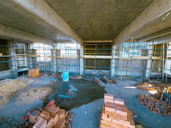 A construction site with a large building in the background. multi-storey building. A construction site with scaffolding and a large building in the background.