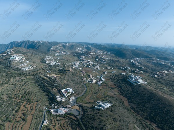 A shot of a series of mountains and green areas in the city of Abha in southern Saudi Arabia, houses on mountain heights, nature in Saudi Arabia