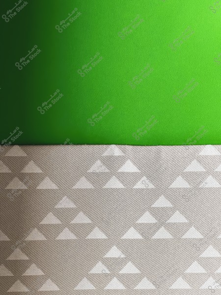 The image shows a simple design consisting of two sections. The upper part is a bright green color with a subtle texture. The lower part features a pattern of repeating white triangles on a light gray background.